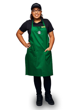 Lead Barista with green apron and black shirt and hat
